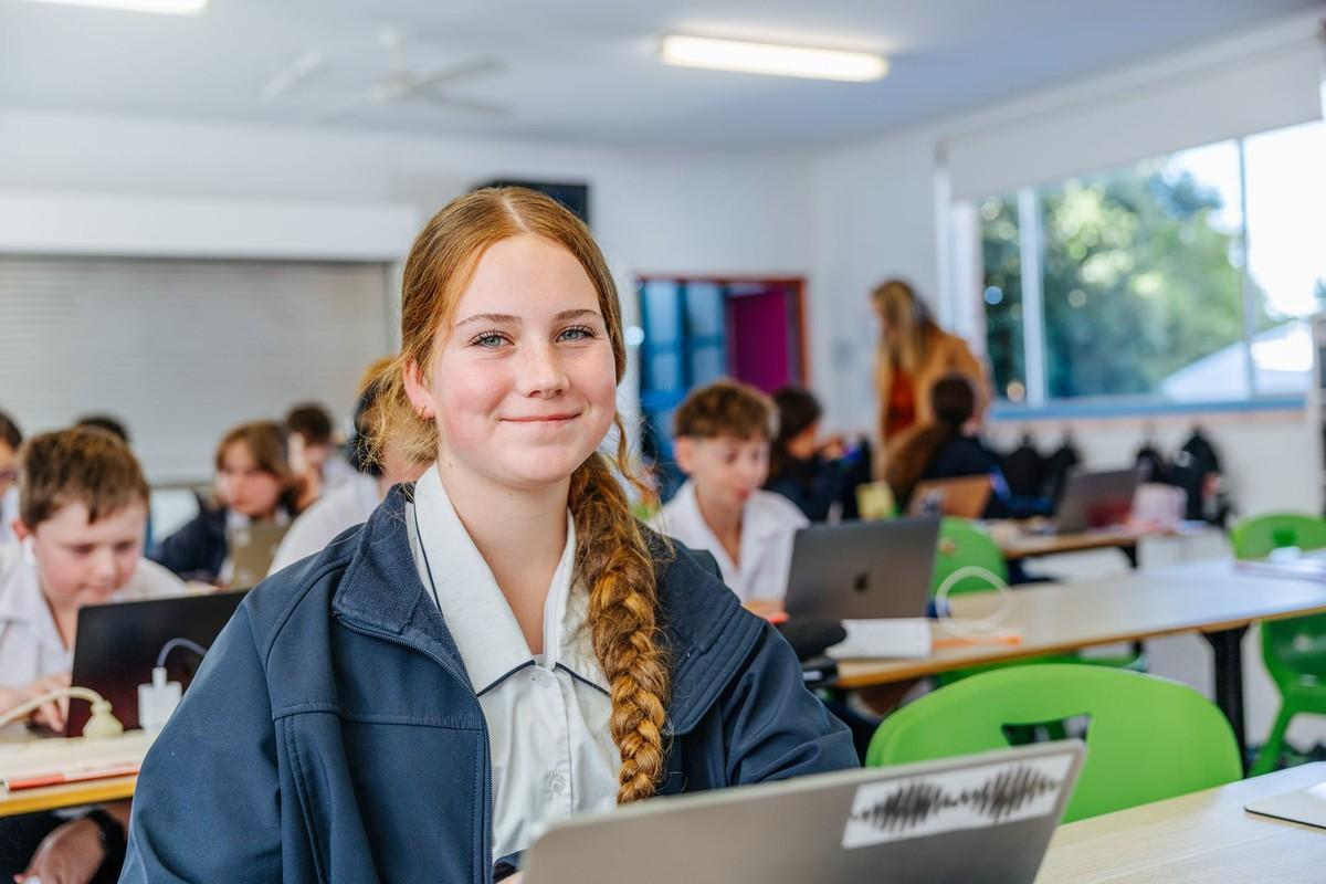 Secondary student with laptop in class — explore secondary school on Lake Macquarie.
