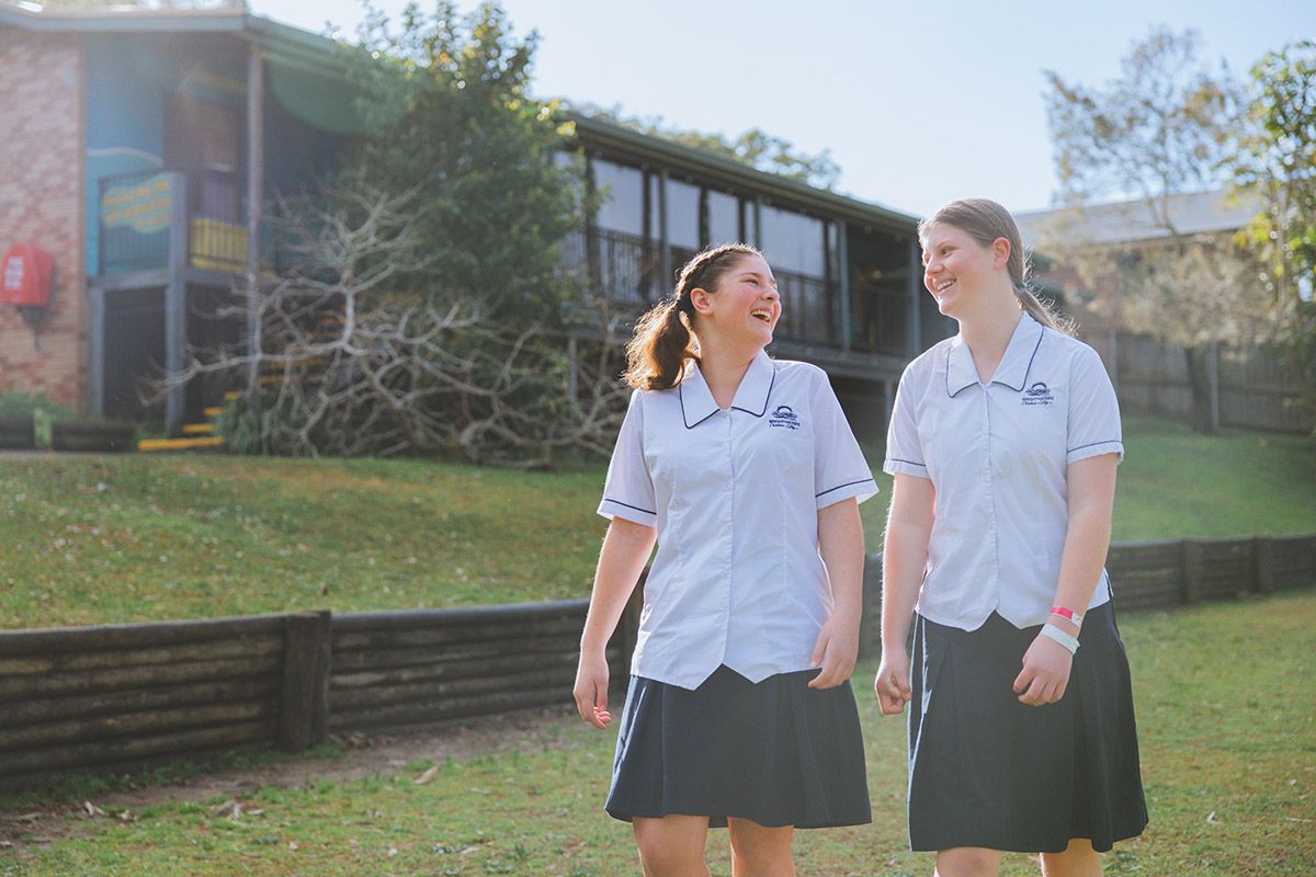 Three happy Brightwaters students walking together along shoreline of Lake Macquarie