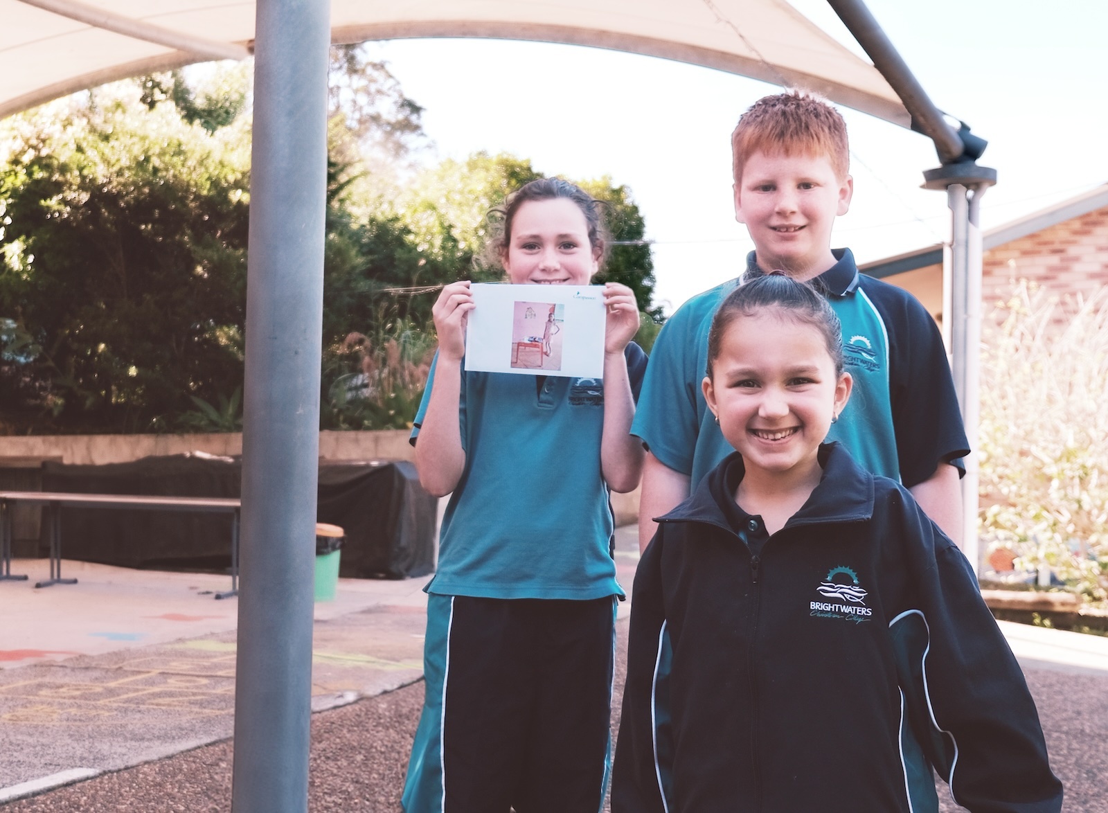 Brightwaters students in light blue uniform walking along Lake Macquarie waterfront